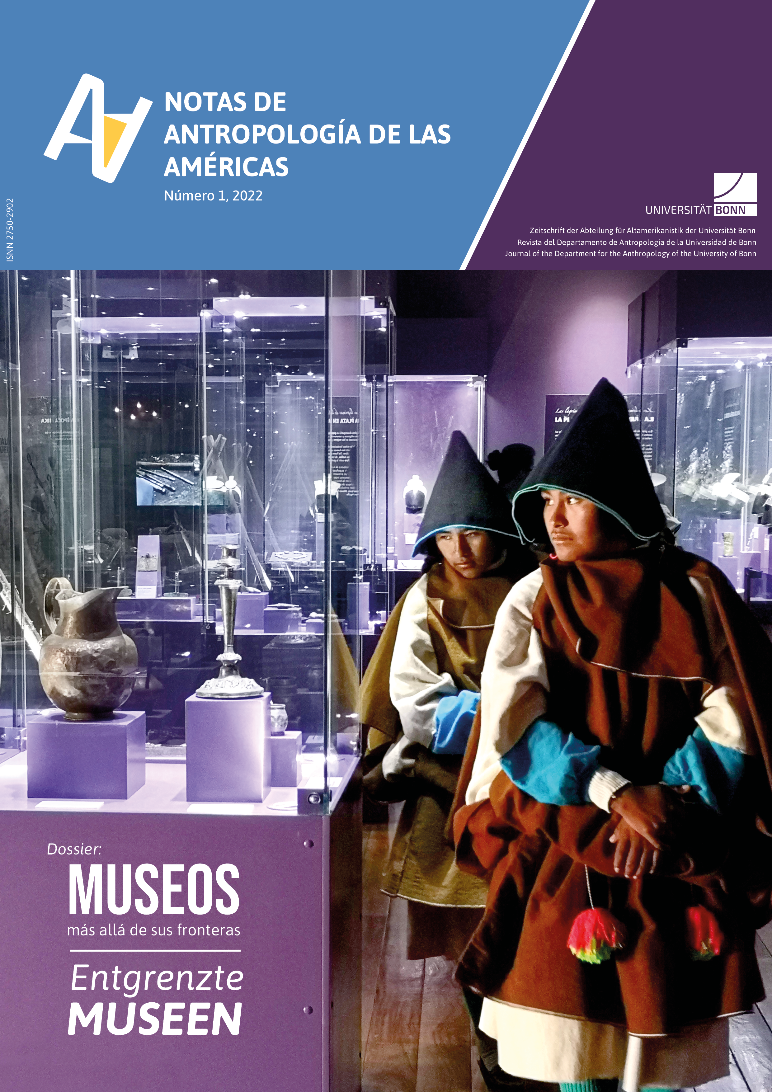 Two people in traditional clothing stand inside a museum gallery with purple-lit glass display cases exhibiting pre-Columbian ceramic and metal artifacts.