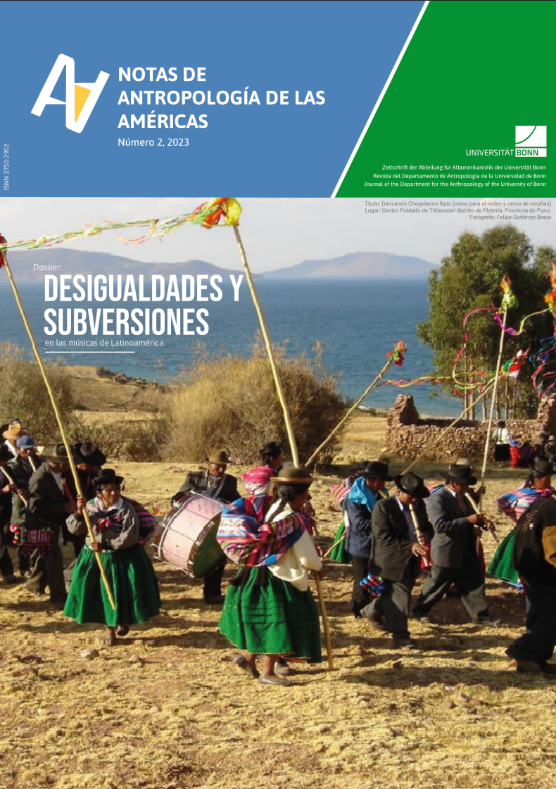 A group of musicians in colorful traditional clothing march and play instruments on a highland landscape near a lake, surrounded by dry vegetation and fluttering ribbons or flags.